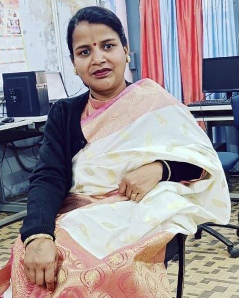 Portrait of Dr. Kapoor wearing traditional attire with academic books in background